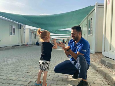 WFP and its partners provides vital support to Syrian and Ukrainian refugees through out the country. WFP Associate Cemil Mahl? ile playing with an Ukranian refugee girl in Elazig Temporary Accommodation Centre. 